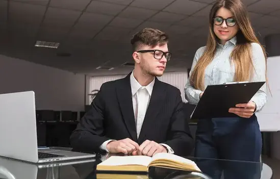 businesswoman-showing-document-male-colleague-office